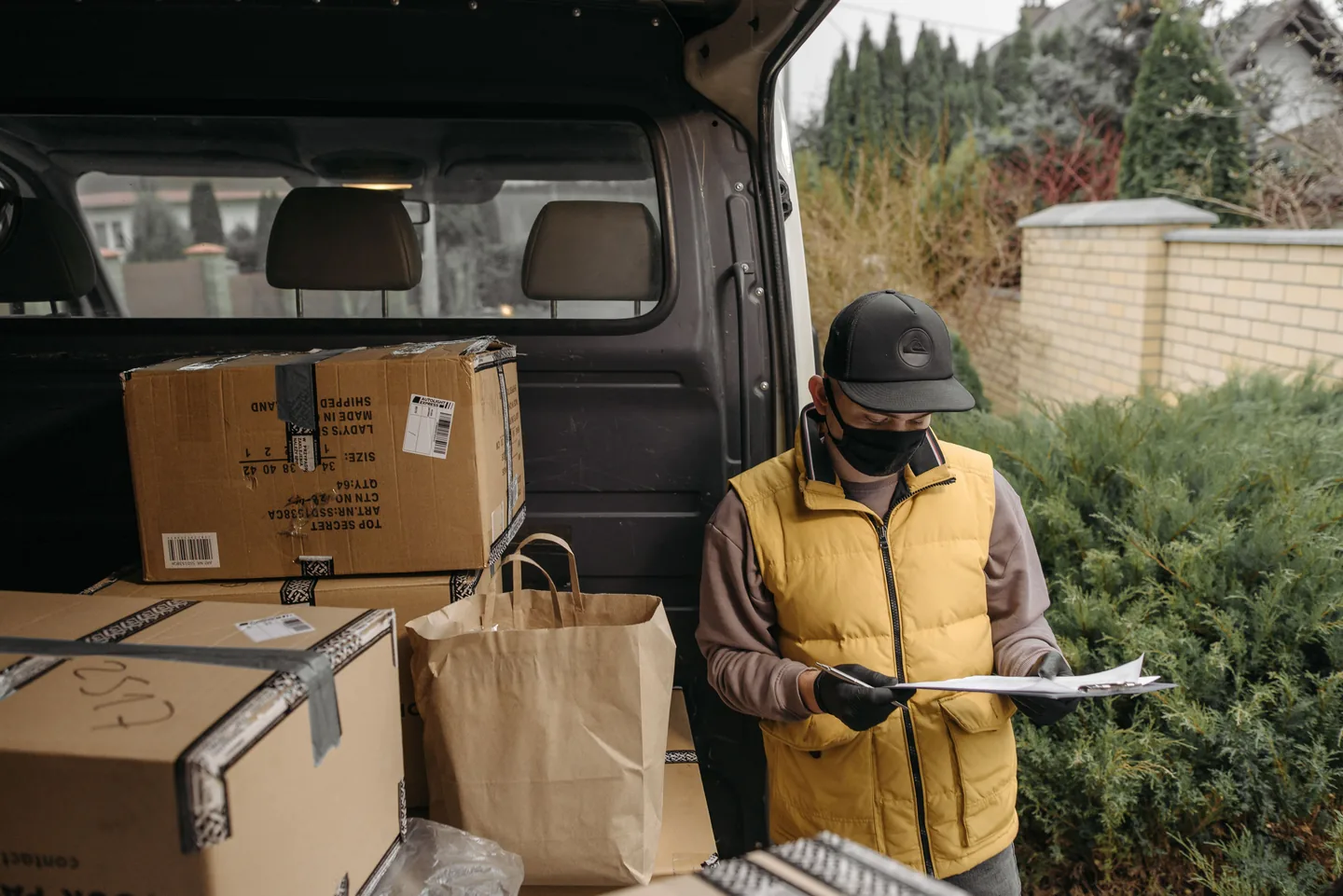 Livreur avec un porte-documents près d’une camionnette